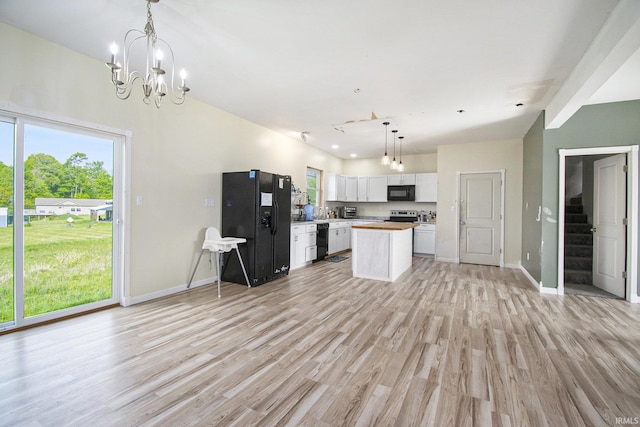 5025 N Elder Rd, Larwill, IN 46764 - kitchen featuring black appliances, white cabinets, light wood-type flooring, and baseboards