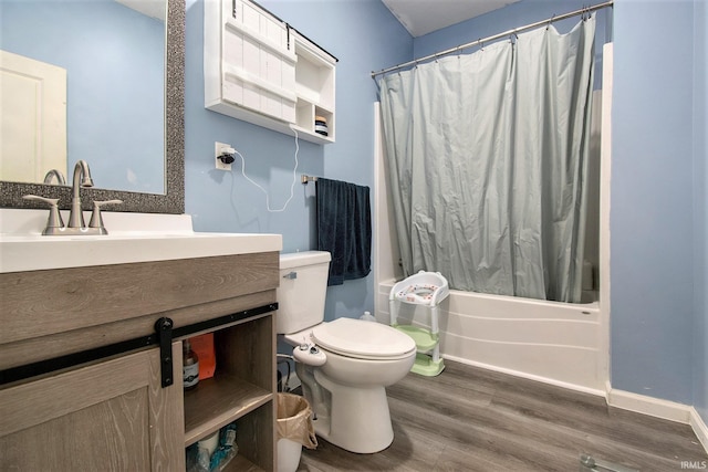 5025 N Elder Rd, Larwill, IN 46764 - full bathroom with wood finished floors, toilet, shower / bath combination with curtain, vanity, and baseboards