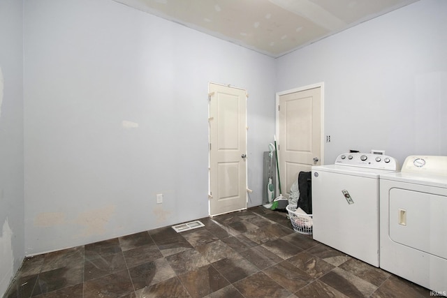 5025 N Elder Rd, Larwill, IN 46764 - clothes washing area with washer and clothes dryer and dark stone finish flooring