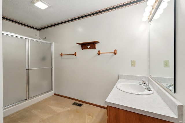 full bathroom with a textured ceiling, a stall shower, vanity, and crown molding