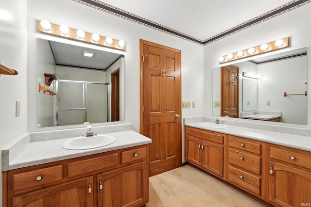 full bathroom featuring a shower stall, vanity, and crown molding