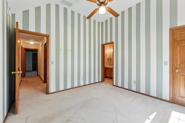 unfurnished bedroom featuring light carpet and baseboards