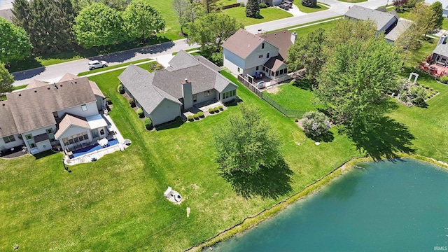 aerial view of residential area featuring a nearby body of water