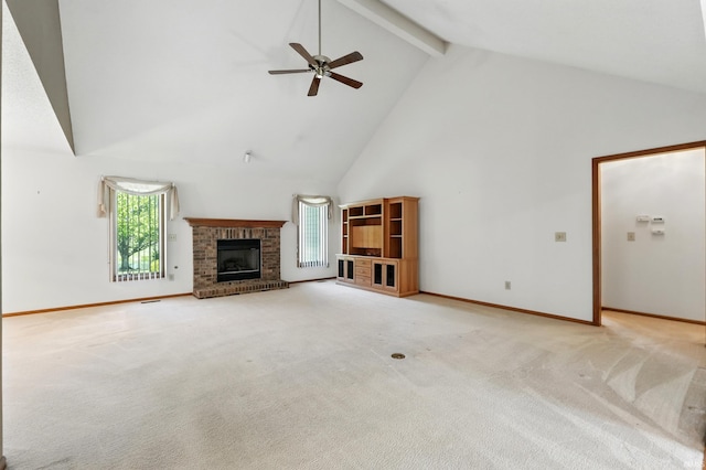 unfurnished living room with high vaulted ceiling, a ceiling fan, a fireplace, beam ceiling, and light colored carpet