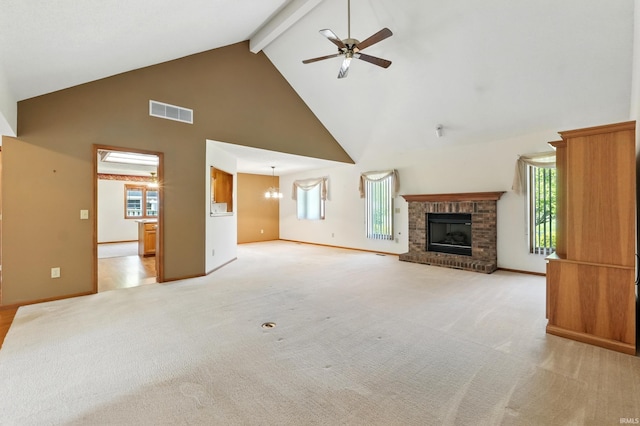 unfurnished living room with high vaulted ceiling, ceiling fan, a brick fireplace, beam ceiling, and plenty of natural light