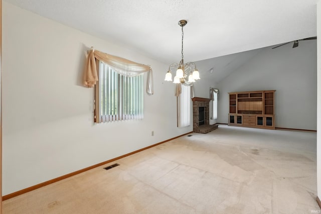 unfurnished living room featuring carpet flooring, a chandelier, a brick fireplace, baseboards, and lofted ceiling