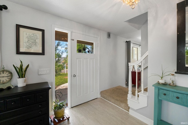 foyer with stairway and light wood-style flooring