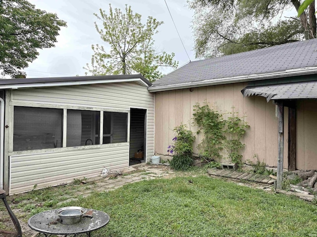 909 N Sullivan St, Alexandria, IN 46001 - back of house with a lawn, a sunroom, and a shingled roof