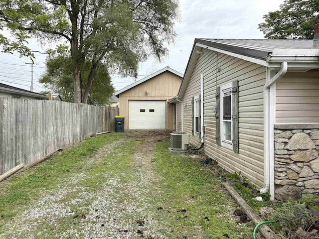 909 N Sullivan St, Alexandria, IN 46001 - view of yard featuring driveway, central AC unit, and a garage