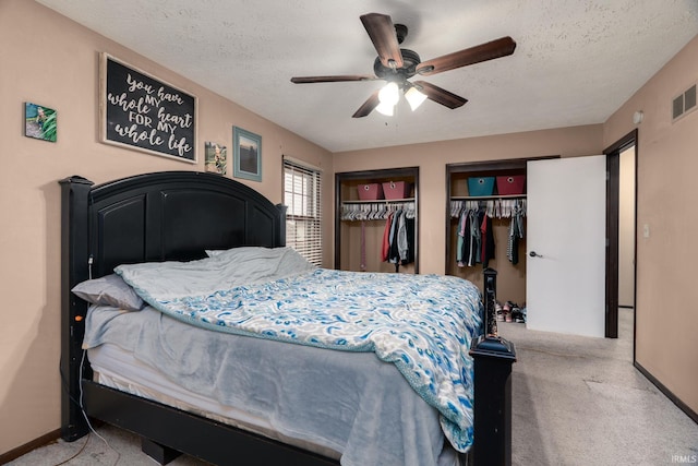 20 Gregory Ct, Lafayette, IN 47905 - carpeted bedroom featuring multiple closets, a textured ceiling, and a ceiling fan