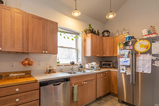 708 W 7th St, Bloomington, IN 47404 - kitchen featuring stainless steel appliances, a sink, light countertops, lofted ceiling, and decorative light fixtures