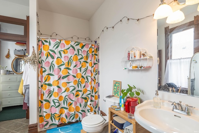 708 W 7th St, Bloomington, IN 47404 - bathroom featuring a sink, a shower with shower curtain, toilet, and tile patterned flooring