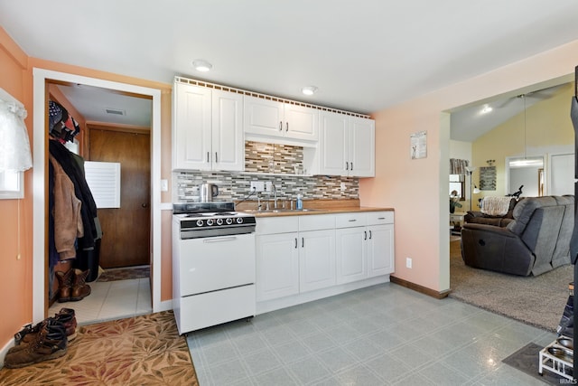kitchen with white range with electric cooktop, a sink, decorative backsplash, white cabinetry, and open floor plan