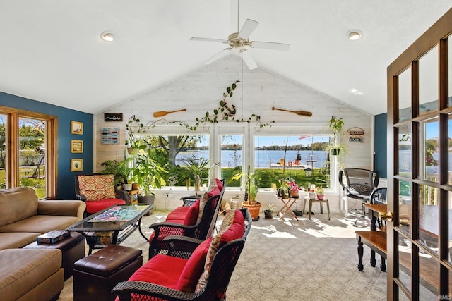 sunroom with vaulted ceiling and a water view
