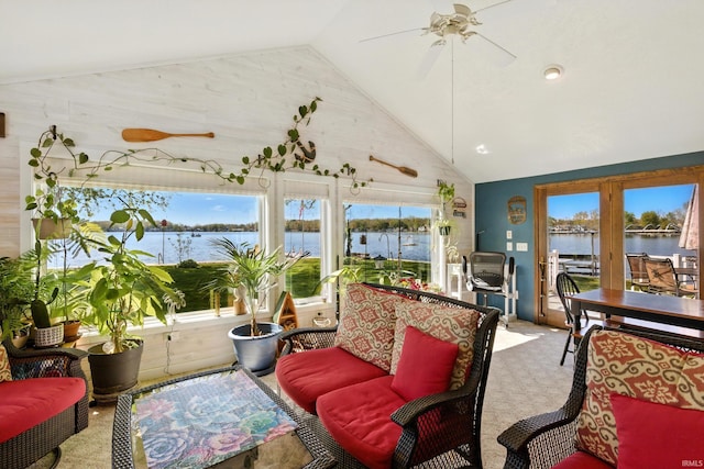 sunroom featuring vaulted ceiling and a water view