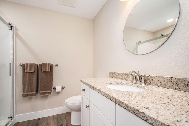 2007 Wakefield Rd, Goshen, IN 46528 - bathroom with a shower stall, wood finished floors, vanity, baseboards, and toilet