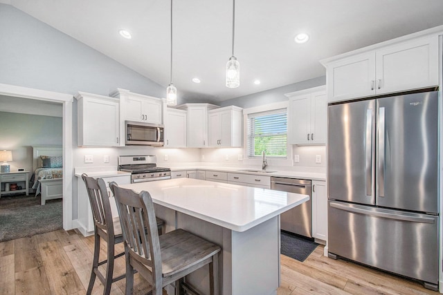 2007 Wakefield Rd, Goshen, IN 46528 - kitchen featuring appliances with stainless steel finishes, a sink, light countertops, white cabinets, and a center island
