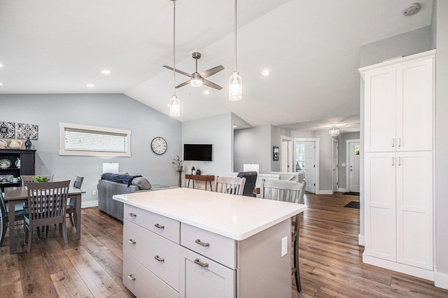 2007 Wakefield Rd, Goshen, IN 46528 - kitchen with open floor plan, a breakfast bar area, a center island, wood finished floors, and vaulted ceiling