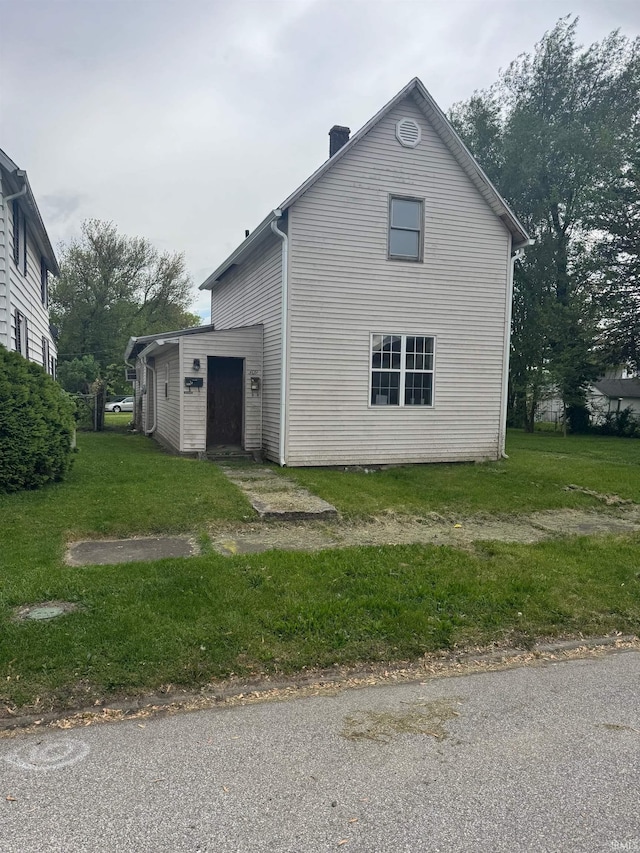 309 Loveland Ave, Peru, IN 46970 - view of side of home with a chimney and a yard