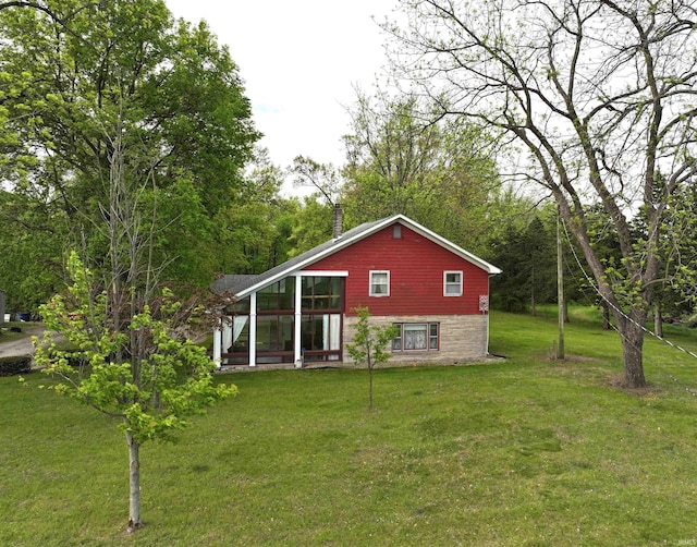 back of property featuring a yard and a chimney