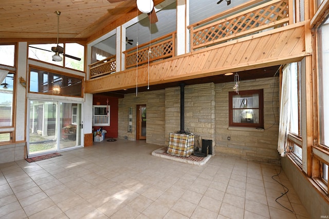 unfurnished sunroom with a wood stove