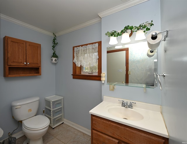 bathroom with baseboards, crown molding, toilet, vanity, and tile patterned flooring