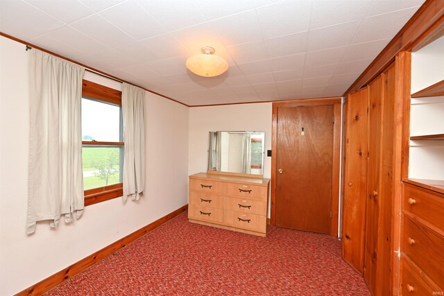 bedroom featuring carpet flooring and baseboards