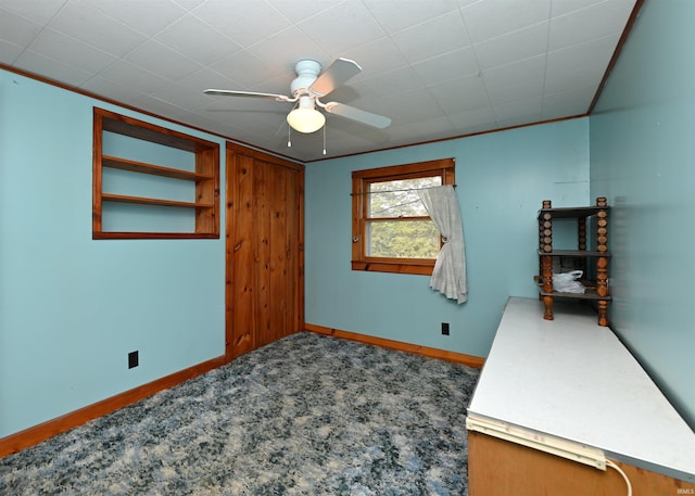 empty room featuring ceiling fan, baseboards, and carpet flooring