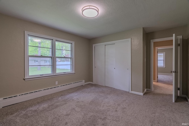 546 W Harrison, Wabash, IN 46992 - unfurnished bedroom with baseboard heating, carpet flooring, a closet, and baseboards