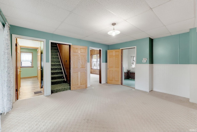 3648 E 300 S, Albion, IN 46701 - unfurnished bedroom featuring carpet floors, a drop ceiling, and a wainscoted wall