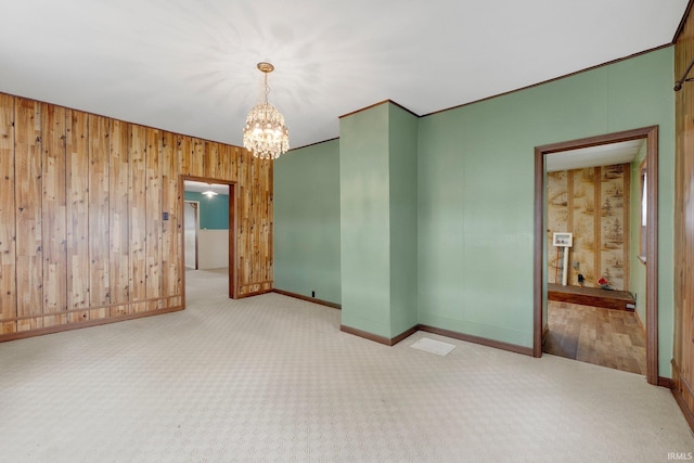 3648 E 300 S, Albion, IN 46701 - carpeted empty room featuring a chandelier, baseboards, and wood walls