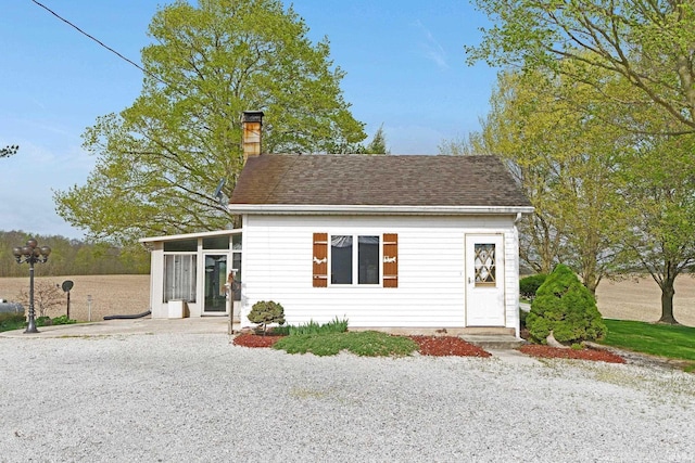 3648 E 300 S, Albion, IN 46701 - view of front of home with a sunroom, a chimney, a shingled roof, and driveway