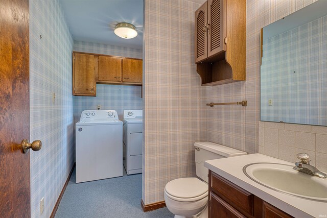 844 Old Plank Rd, Chandler, IN 47610 - half bathroom with independent washer and dryer, toilet, wallpapered walls, and vanity