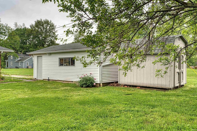 844 Old Plank Rd, Chandler, IN 47610 - rear view of house featuring a yard, an outbuilding, and a shingled roof