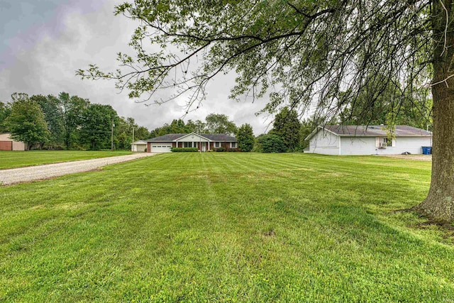 844 Old Plank Rd, Chandler, IN 47610 - view of grassy yard featuring driveway and a garage