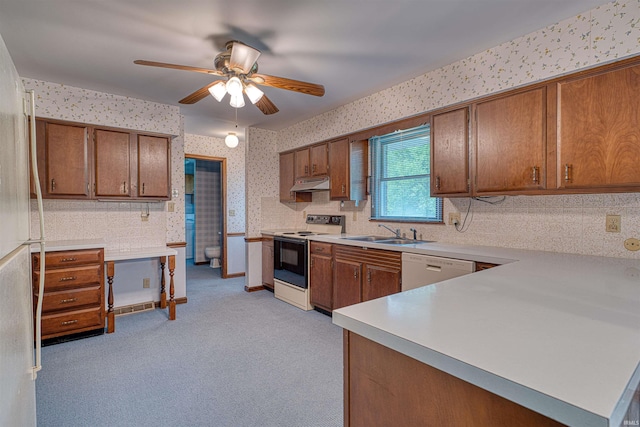 844 Old Plank Rd, Chandler, IN 47610 - kitchen with electric range, wallpapered walls, under cabinet range hood, a sink, and brown cabinets