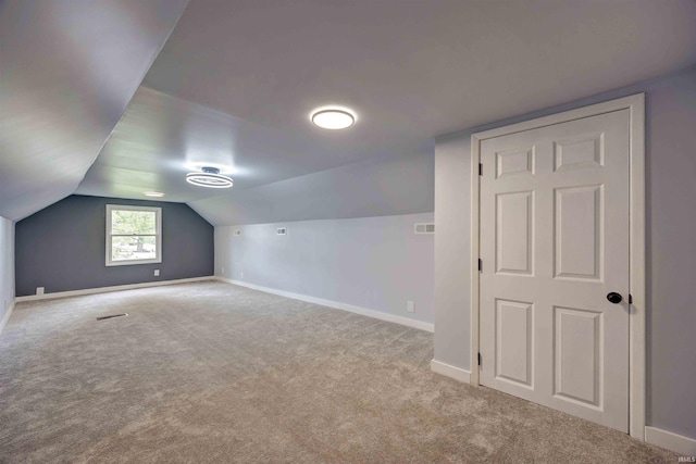 bonus room with carpet flooring, baseboards, and vaulted ceiling