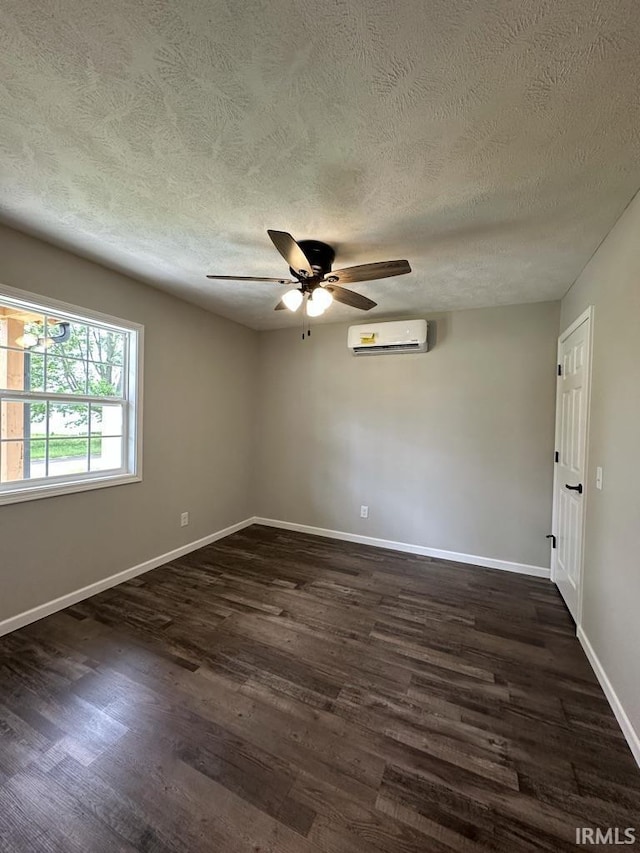 403 S Meridian St, Jasonville, IN 47438 - empty room with dark wood-style flooring, baseboards, a textured ceiling, a ceiling fan, and a wall mounted air conditioner