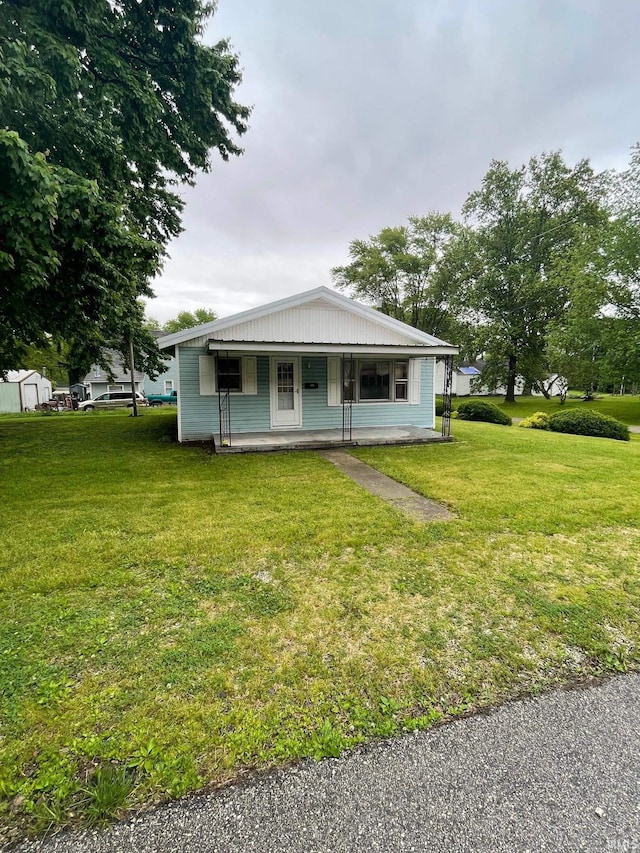 109 S 3rd St, Edwardsport, IN 47528 - view of front of home featuring covered porch and a front yard