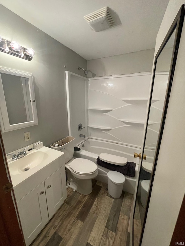 109 S 3rd St, Edwardsport, IN 47528 - full bathroom featuring wood finished floors, toilet, vanity, and shower / tub combination