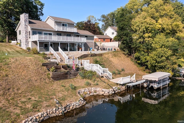 10140 Jefferson Rd, Osceola, IN 46561 - rear view of house with stairway, a chimney, boat lift, a deck with water view, and a lawn