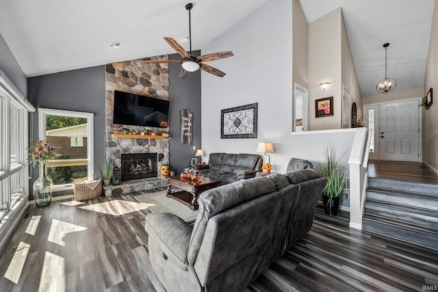 10140 Jefferson Rd, Osceola, IN 46561 - living area featuring wood finished floors, a stone fireplace, a ceiling fan, baseboards, and high vaulted ceiling