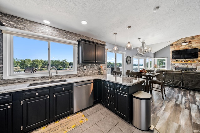 10140 Jefferson Rd, Osceola, IN 46561 - kitchen with stainless steel dishwasher, a sink, dark cabinetry, a chandelier, and a textured ceiling