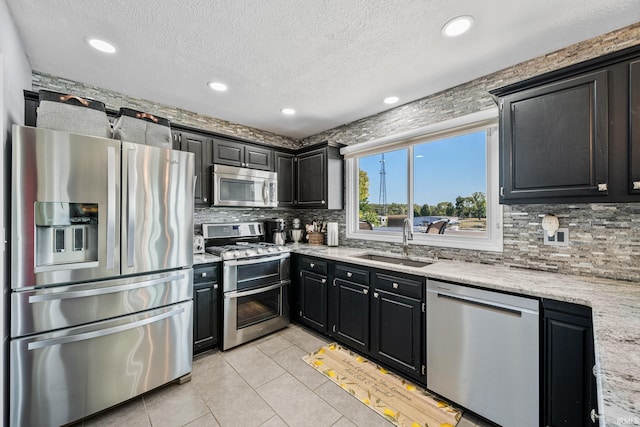 10140 Jefferson Rd, Osceola, IN 46561 - kitchen featuring stainless steel appliances, a sink, light tile patterned floors, tasteful backsplash, and a textured ceiling
