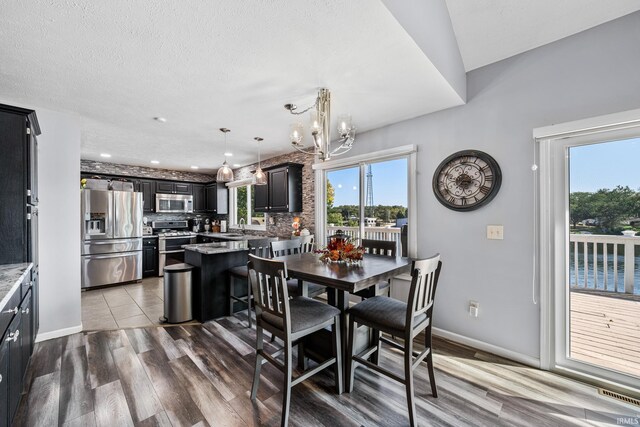 10140 Jefferson Rd, Osceola, IN 46561 - dining space featuring a chandelier, wood finished floors, baseboards, and recessed lighting