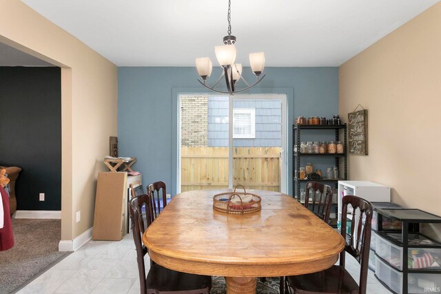 3205 S Michigan St, South Bend, IN 46614 - dining space with a chandelier, light marble finish flooring, and baseboards