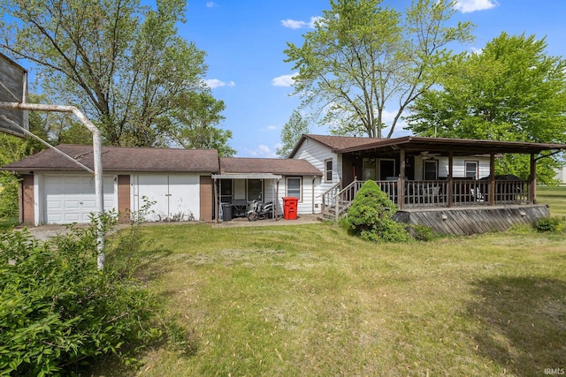 view of front of home with a front lawn, a garage, and covered porch