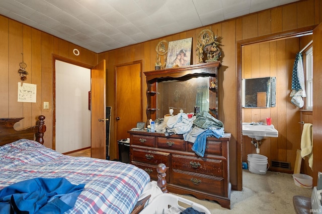 carpeted bedroom with wooden walls