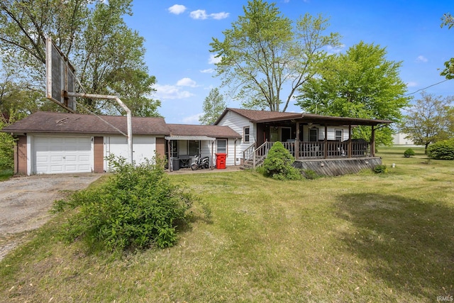 view of front of home featuring a porch, a front lawn, driveway, and an attached garage