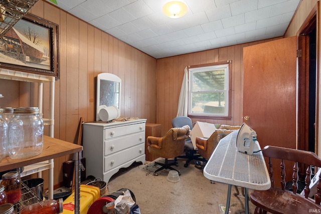 carpeted office featuring wood walls